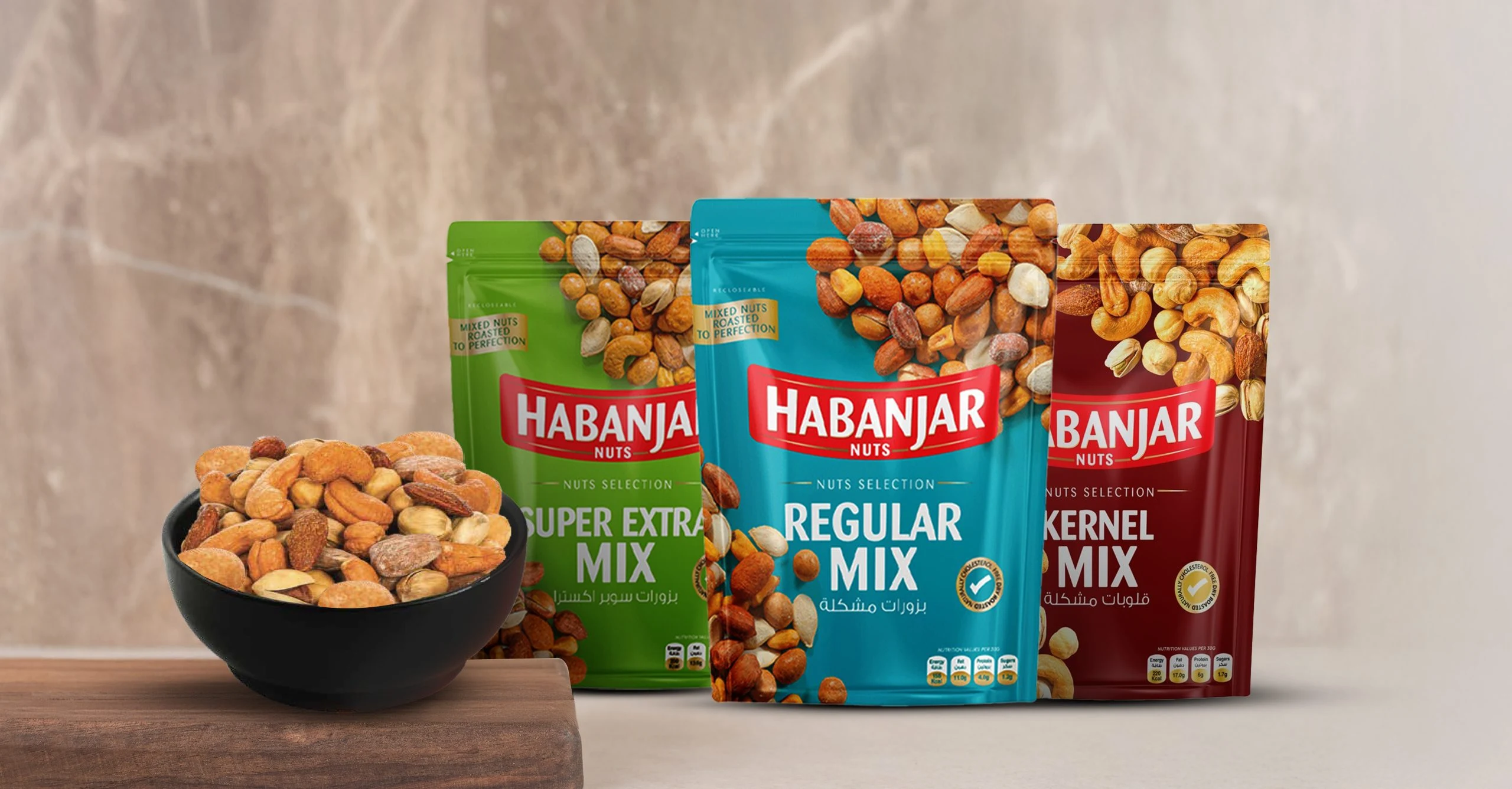 Habanjar Super Extra Mix, Regular Mix and Kernel Mix resealable bags beside a bowl of mixed nuts